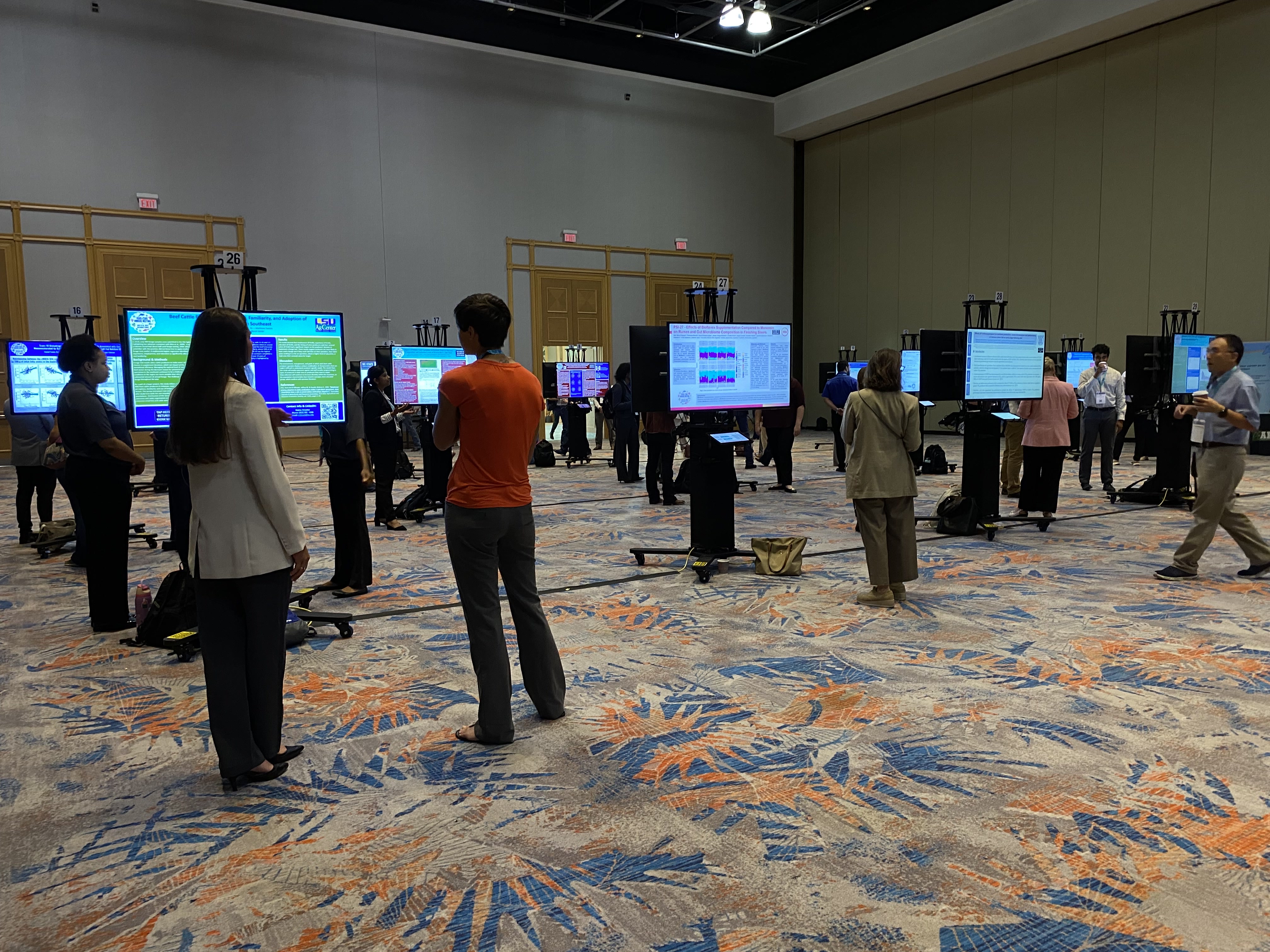 A busy digital poster session in an open venue
