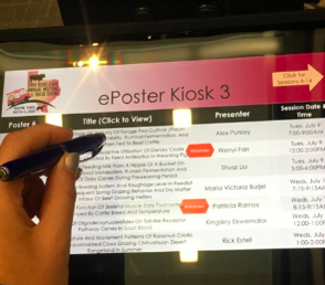 Attendee using an ePoster kiosk schedule