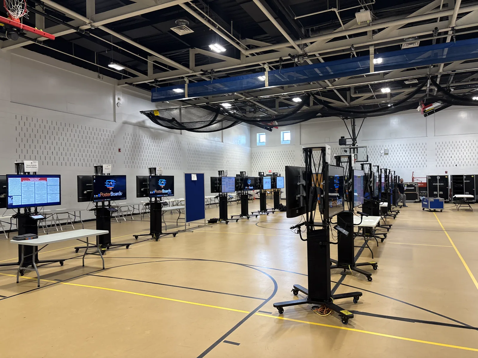 Digital ePoster boards arranged across a conference space