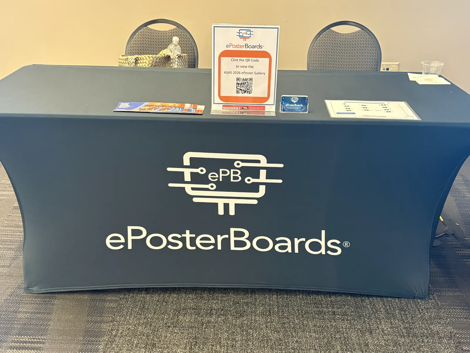ePosterBoards help desk with a branded support table and conference materials