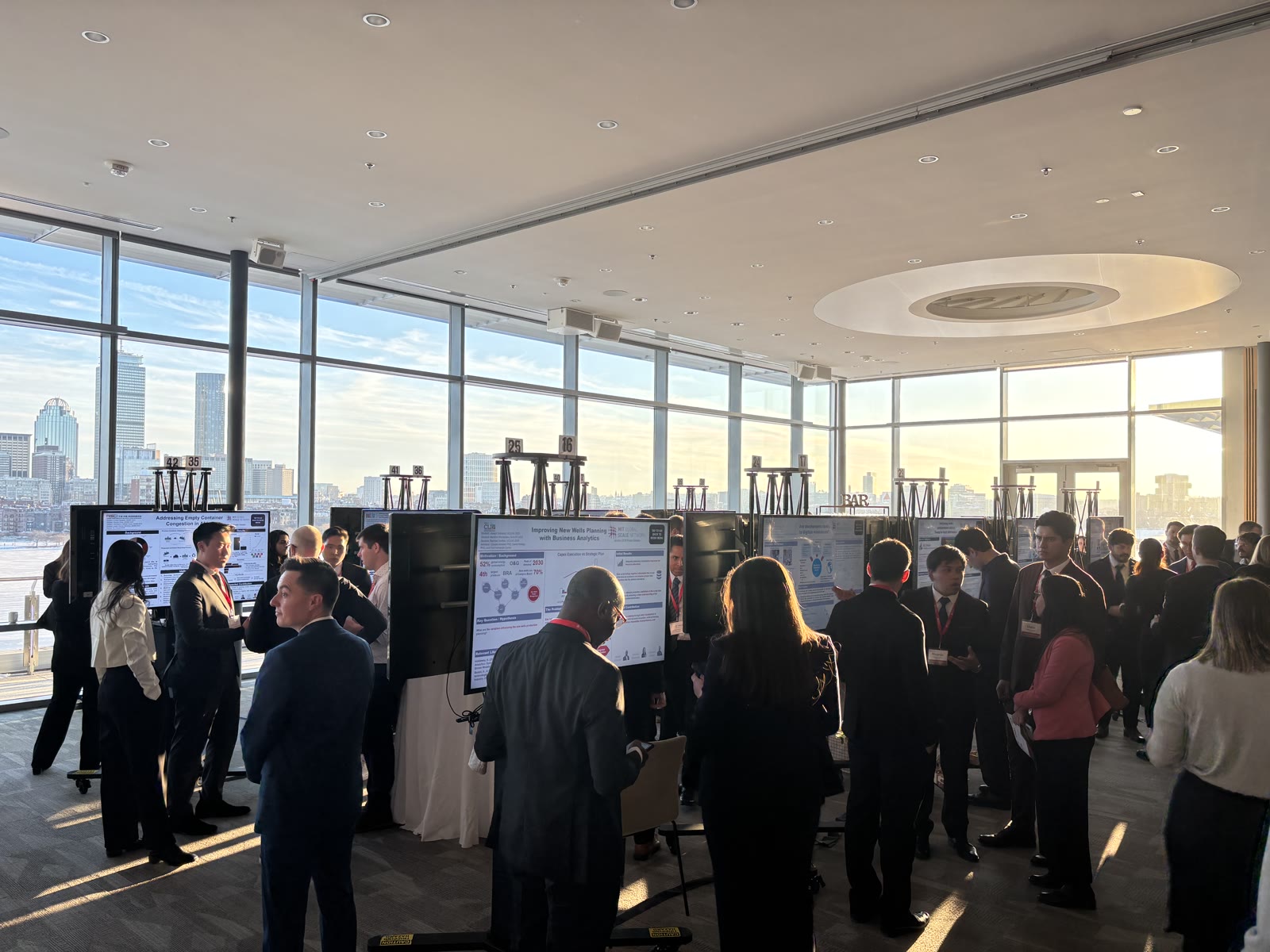 Digital poster presentations set against the Boston skyline