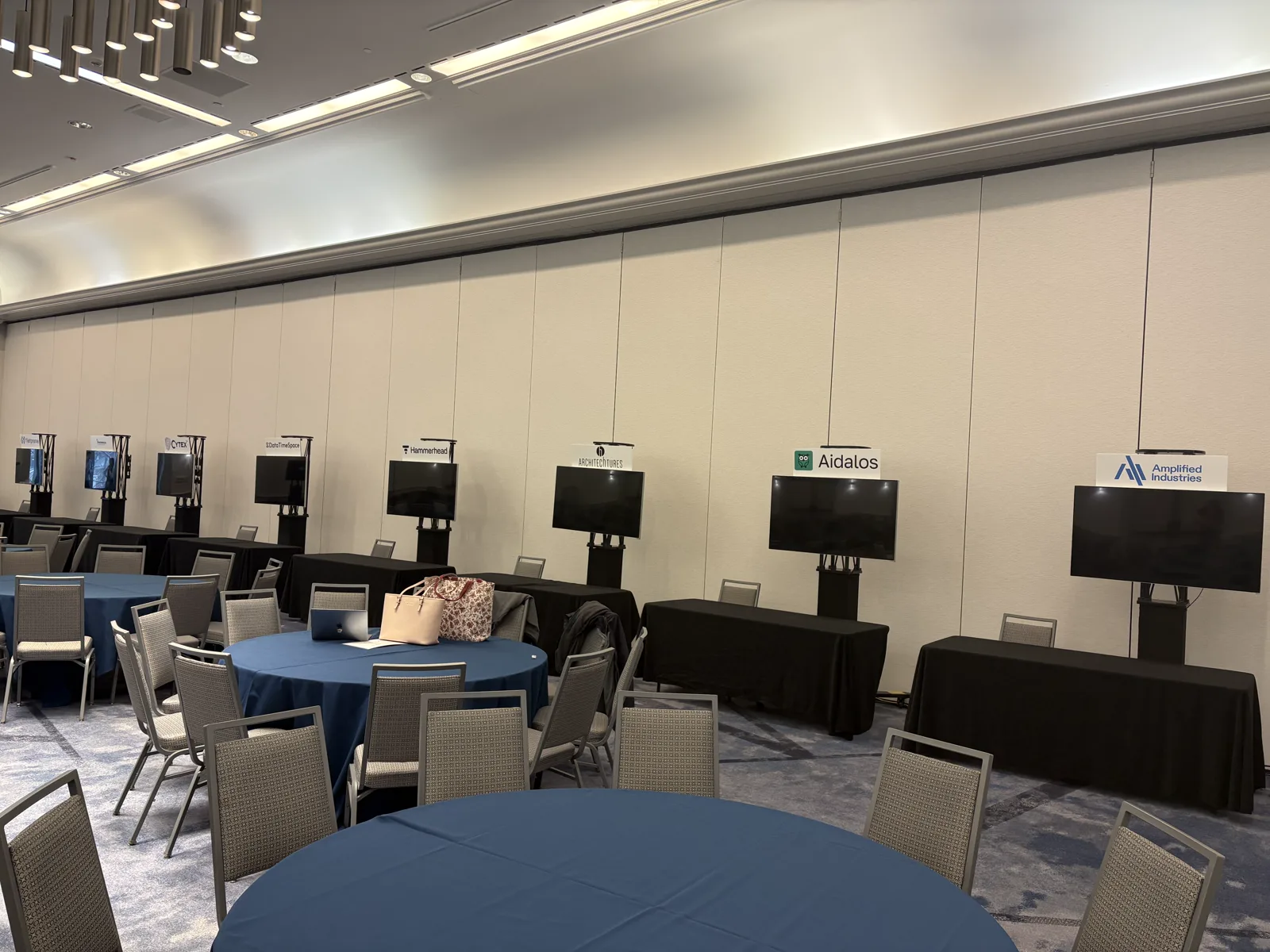 Attendees exploring digital poster displays in a conference hall