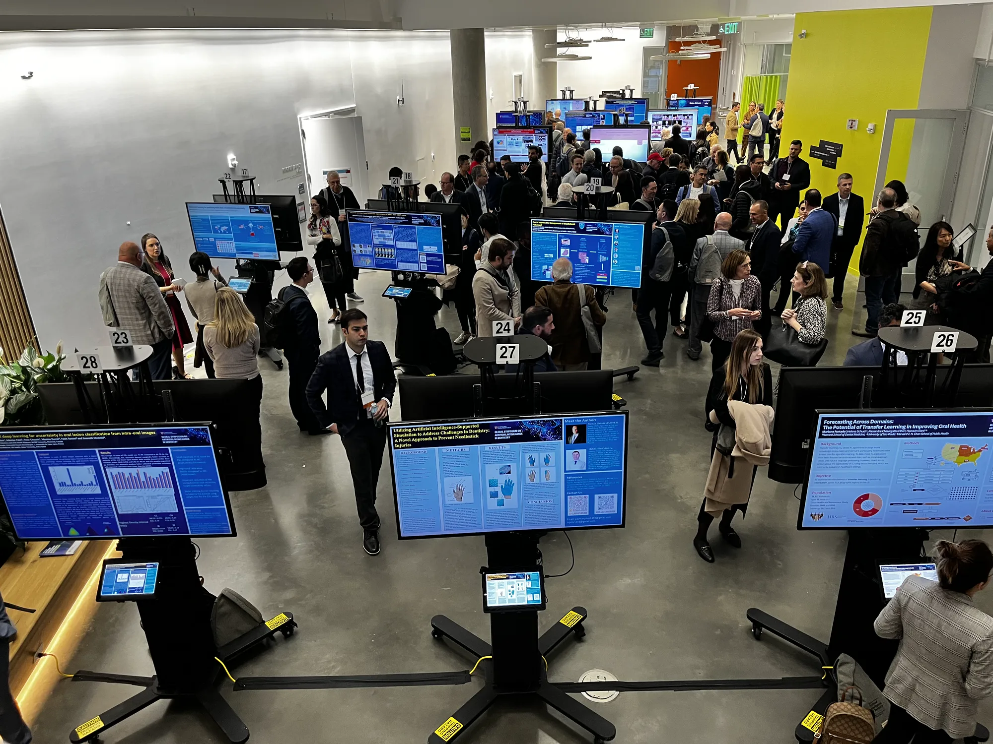 Attendees moving through a busy digital poster session